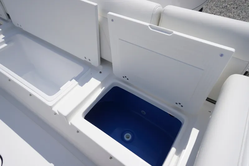 Slide: The Image of 2027 Tidewater 256 LXF boat storage compartments with open lids, showcasing interior space. - 61