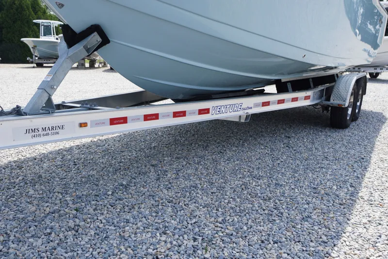 Slide: The Image of 2027 Tidewater 256 LXF boat on Venture trailer at Jim's Marine dealership. - 79