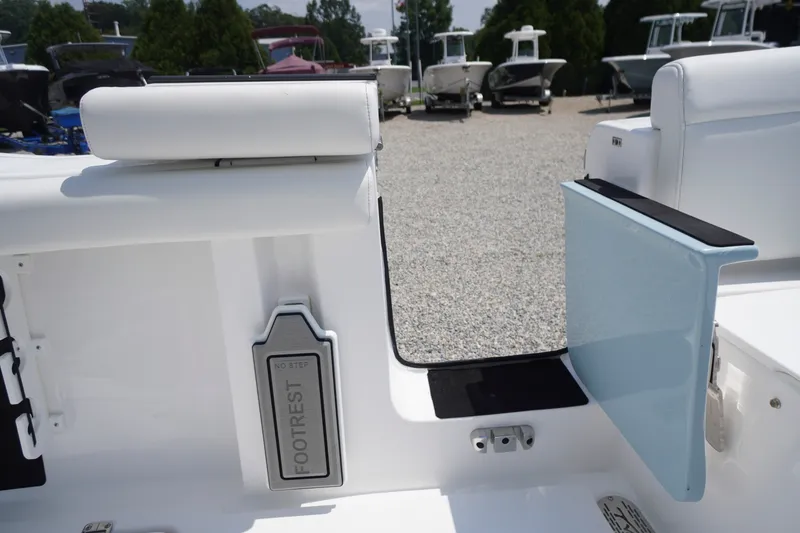 Slide: The Image of 2027 Tidewater 256 LXF boat interior with footrest and open side door. - 63