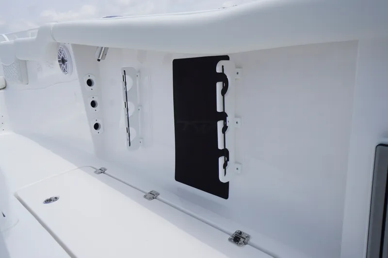 Slide: The Image of 2027 Tidewater 256 LXF boat interior detail with storage compartments and speaker. - 67