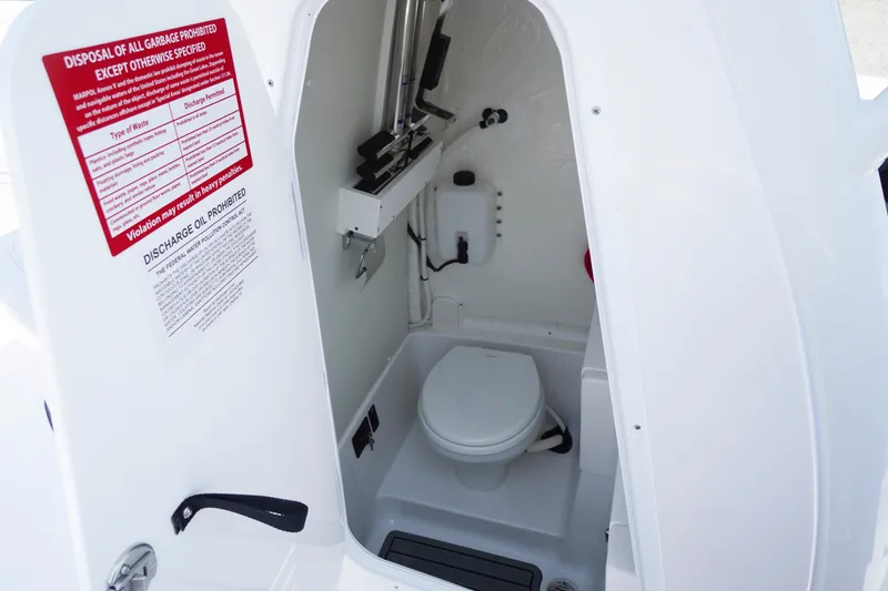 Slide: The Image of Interior view of 2027 Tidewater 256 LXF boat's compact marine toilet area. - 26