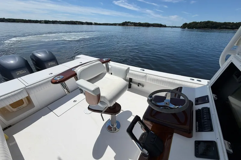 Slide: The Image of 2007 Regulator 29 Forward Seating boat with dual Yamaha 250 engines on a calm lake. - 55