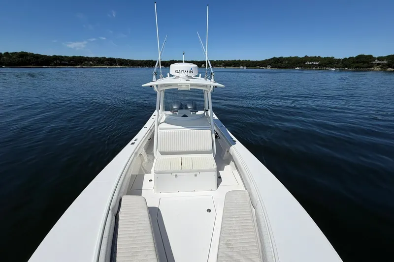 Slide: The Image of 2007 Regulator 29 Forward Seating boat on calm water, clear sky background. - 62