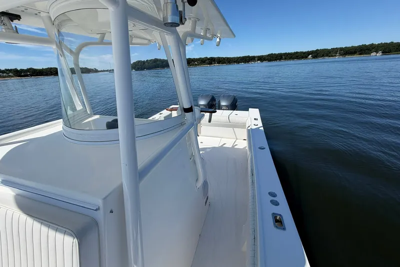 Slide: The Image of 2007 Regulator 29 Forward Seating boat on calm water, showcasing spacious deck and twin engines. - 40