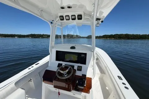 Slide: The Image of 2007 Regulator 29 Forward Seating boat on calm water, featuring a sleek helm design. - 43