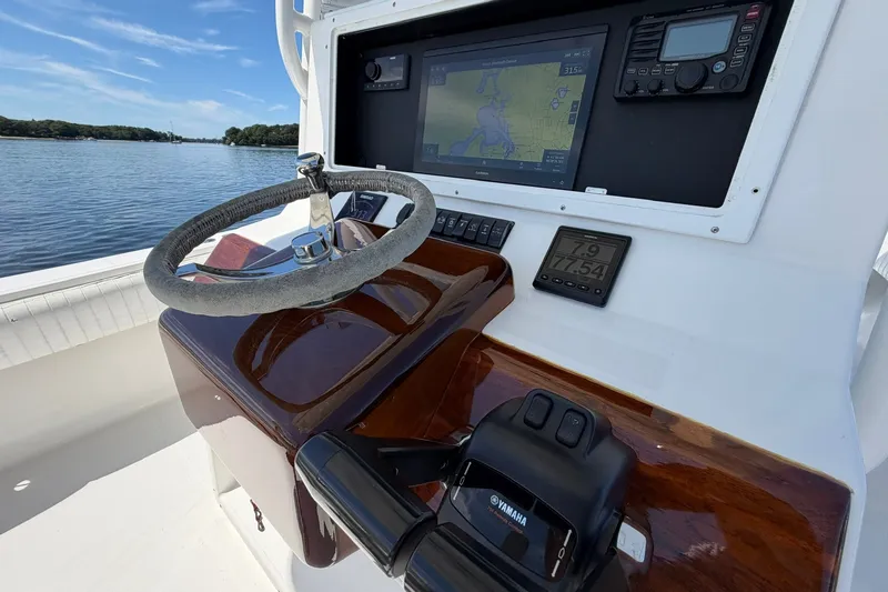 Slide: The Image of 2007 Regulator 29 Forward Seating boat dashboard with steering wheel and navigation display. - 59