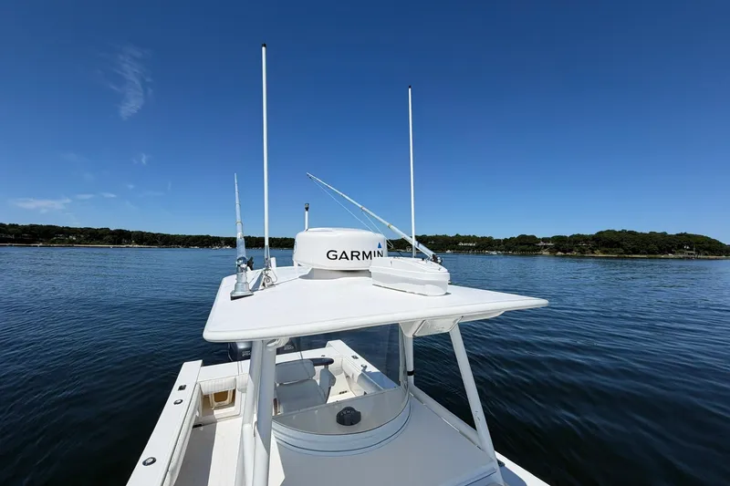 Slide: The Image of 2007 Regulator 29 Forward Seating boat on calm water with Garmin equipment. - 39