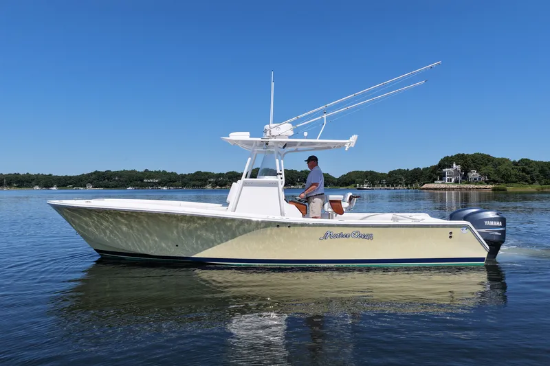 Slide: The Image of 2007 Regulator 29 Forward Seating boat on calm water, clear sky background. - 6