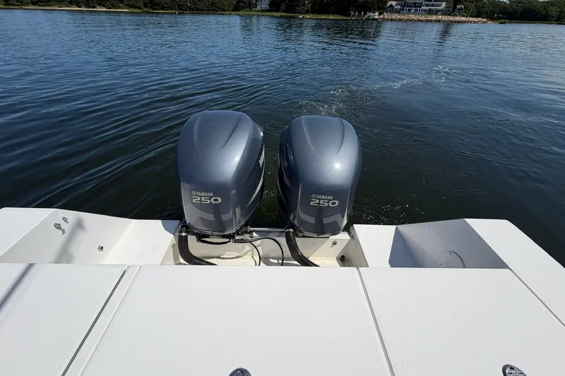 Slide: The Image of 2007 Regulator 29 Forward Seating boat with twin Yamaha 250 engines on calm water. - 49
