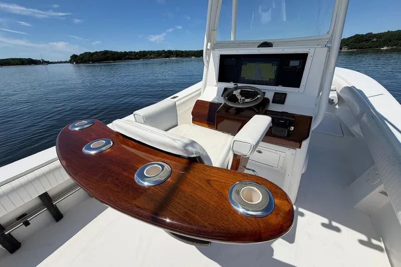 Slide: The Image of 2007 Regulator 29 Forward Seating boat interior with steering console and wooden accents. - 60