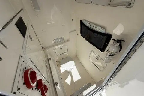 Slide: The Image of 2007 Regulator 29 Forward Seating boat interior with storage and safety equipment. - 54