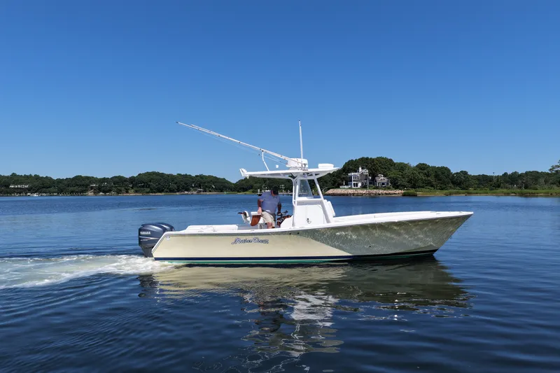 Slide: The Image of 2007 Regulator 29 Forward Seating boat cruising on a calm lake under clear blue skies. - 18