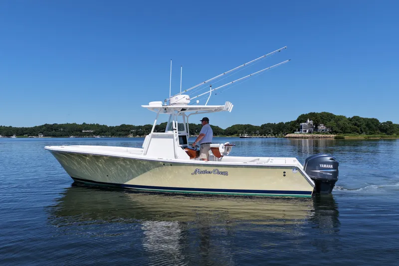 Slide: The Image of 2007 Regulator 29 Forward Seating boat cruising on calm water under clear blue sky. - 7
