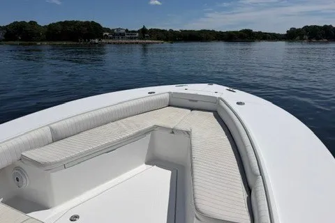 Slide: The Image of 2007 Regulator 29 Forward Seating boat on calm water, featuring spacious seating. - 61