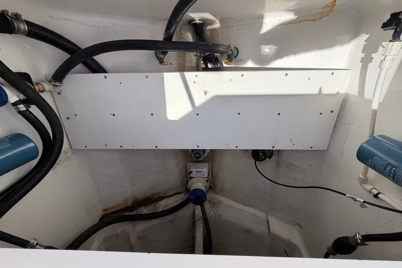 Slide: The Image of 2007 Regulator 29 Forward Seating boat interior with visible hoses and components. - 48