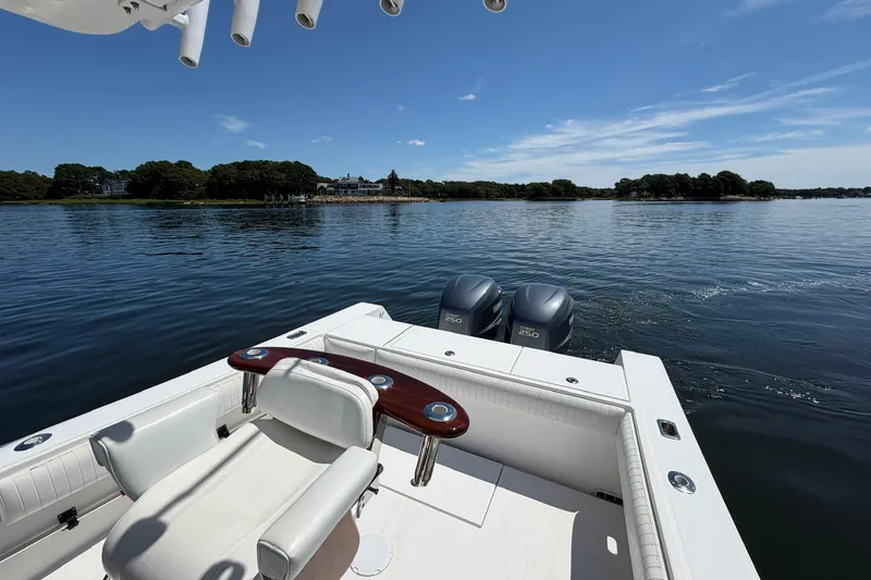 Slide: The Image of 2007 Regulator 29 Forward Seating boat on calm water with scenic shoreline view. - 46