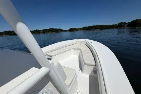 Slide: The Image of 2007 Regulator 29 Forward Seating boat on calm water, showcasing spacious seating and sleek design. - 42