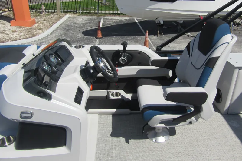 Slide: The Image of 2026 Tahoe Pontoon LTZ Cruise Rear Bench 23 cockpit with modern steering and seating. - 16