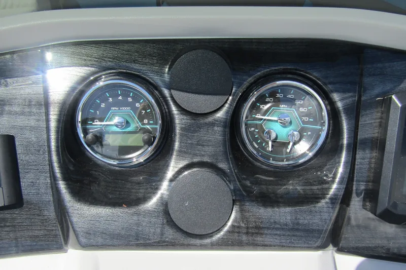 Slide: The Image of Dashboard of 2026 Tahoe Pontoon LTZ Cruise Rear Bench 23 with gauges. - 19