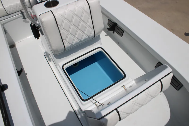 Slide: The Image of 2022 Beavertail Skiffs Mosquito 18' boat interior with cushioned seating and storage compartment. - 18