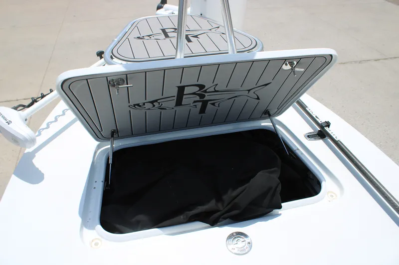 Slide: The Image of 2022 Beavertail Skiffs Mosquito 18' storage compartment with open hatch and logo. - 19