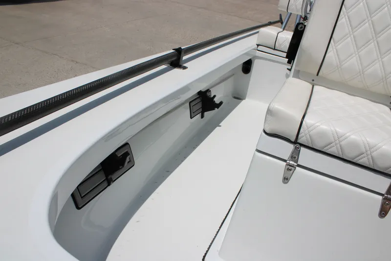 Slide: The Image of 2022 Beavertail Skiffs Mosquito 18' interior with white seating and storage compartments. - 20