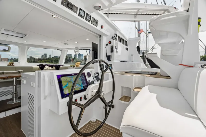 Slide: The Image of Modern Balance 526 yacht cockpit with navigation system, luxurious seating, and city skyline view, 2025 model. - 29