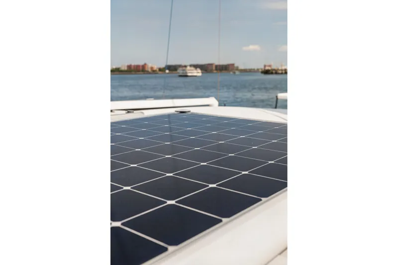 Slide: The Image of Solar panel on Balance 526 yacht, 2025 model, with ocean and cityscape background. - 118