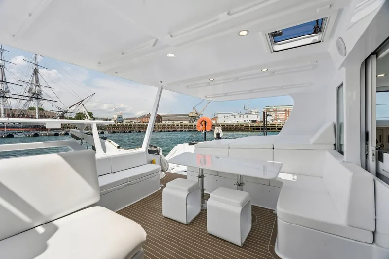 Slide: The Image of Luxurious 2025 Balance 526 yacht interior with sleek white seating and waterfront view. - 37