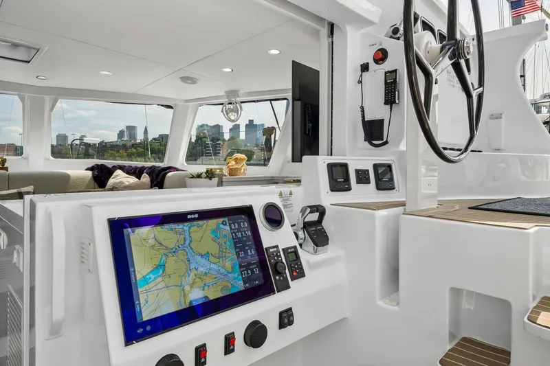 Slide: The Image of Modern Balance 526 yacht cockpit with navigation system, steering wheel, and city skyline view. - 30