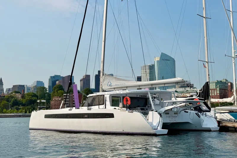 The Image of Modern Balance 526 catamaran docked in urban marina, city skyline in background, 2025 model. - 0