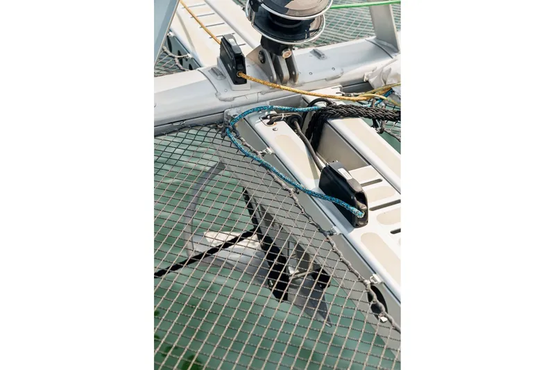 Slide: The Image of Close-up of Balance 526 catamaran rigging and netting, 2025 model, over water. - 129
