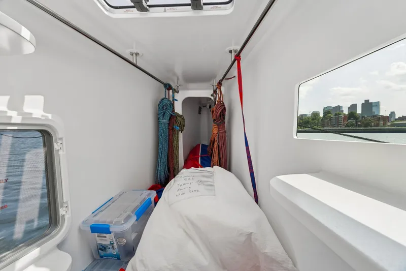 Slide: The Image of Interior of Balance 526 yacht, showcasing storage area with ropes and cityscape view. - 74
