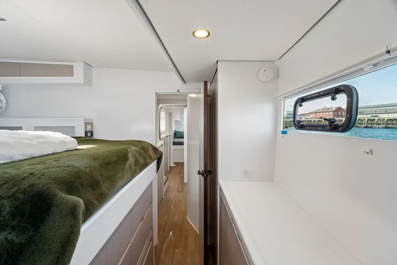 Slide: The Image of Luxurious interior of 2025 Balance 526 yacht with cozy bedding and scenic window view. - 83