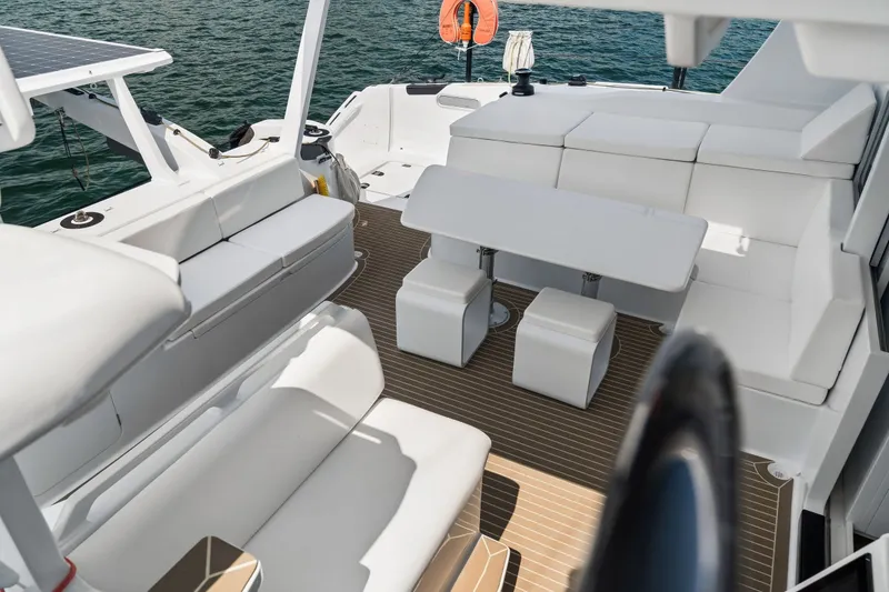Slide: The Image of Luxurious seating area on Balance 526 yacht, 2025 model, with white cushions and ocean view. - 21
