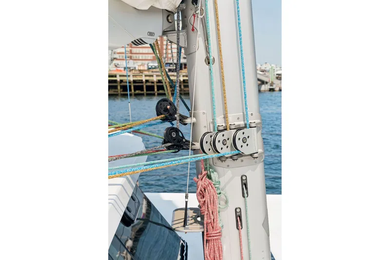 Slide: The Image of Sailboat rigging on Balance 526, 2025 model, with colorful ropes and pulleys by the water. - 125