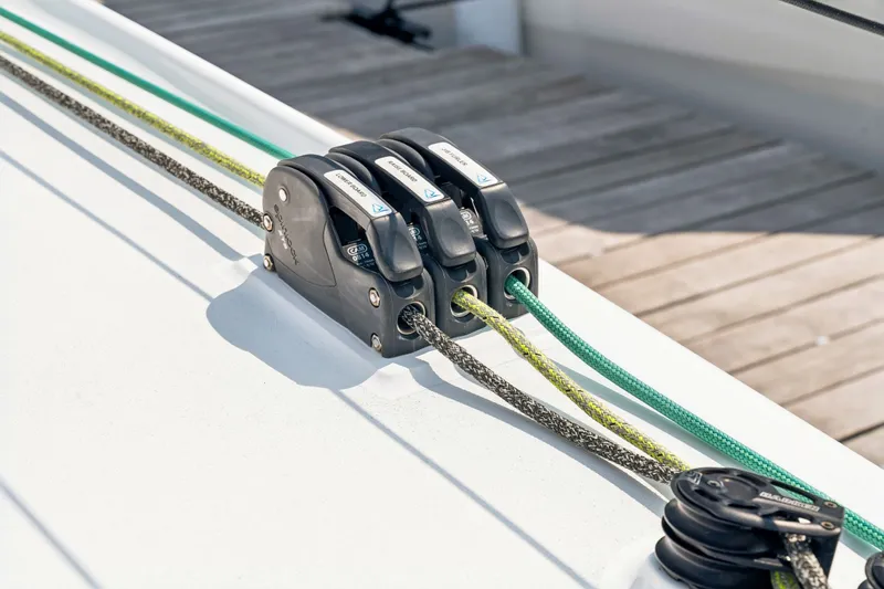 Slide: The Image of Close-up of Balance 526 sailboat rigging system, featuring ropes and pulleys, 2025 model. - 124