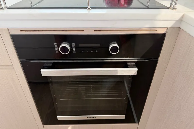 Slide: The Image of Modern built-in oven with sleek design, featuring dual knobs and digital display, Balance 526 model. - 44