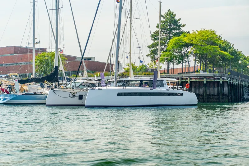 Slide: The Image of Modern Balance 526 catamaran docked at a marina, surrounded by other sailboats. - 136