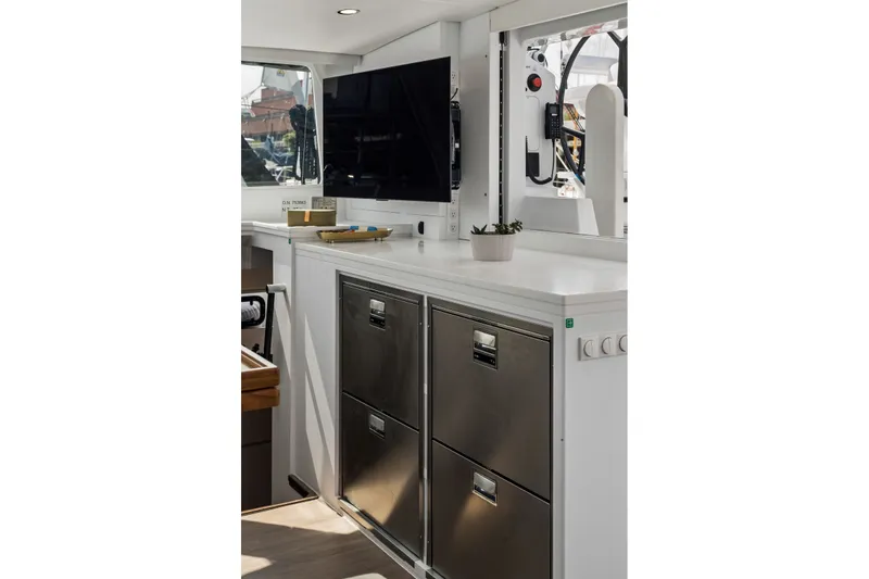 Slide: The Image of Modern yacht interior with stainless steel drawers, TV, and countertop plant. Balance 526, 2025 model. - 59