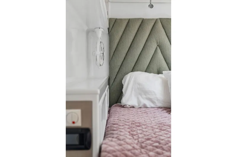 Slide: The Image of Cozy bedroom with quilted pink bedding and textured green headboard in Balance 526, 2025 model. - 71
