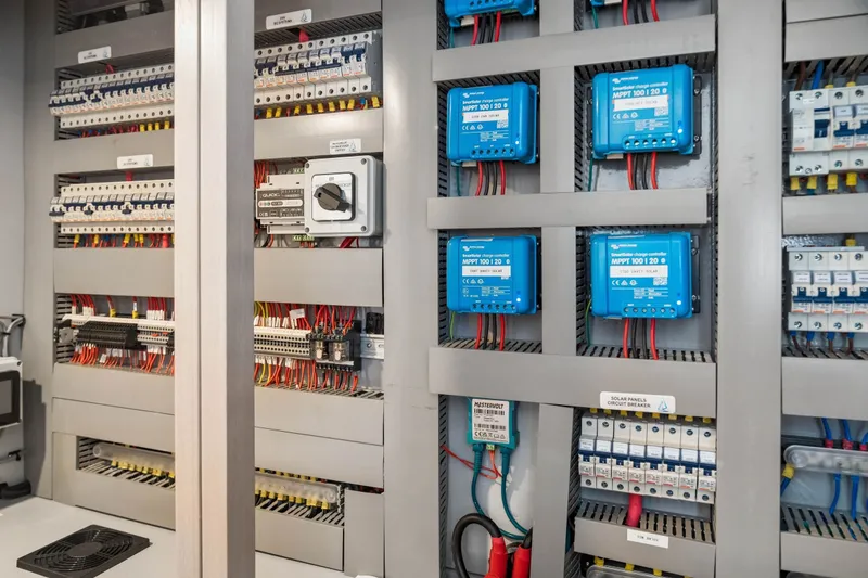 Slide: The Image of Electrical panel with Balance 526 components, featuring circuit breakers and blue charge controllers, 2025 model. - 93