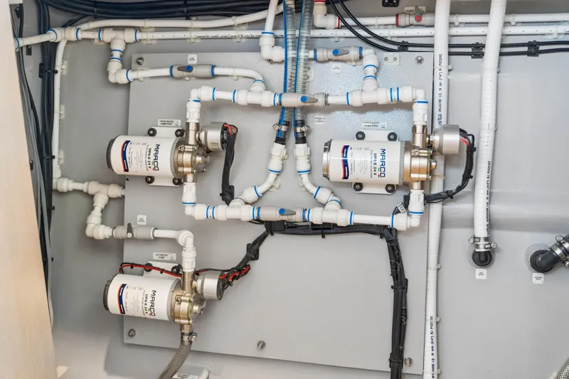 Slide: The Image of Plumbing system in a 2025 Balance 526 model, featuring Marco pumps and connectors. - 103