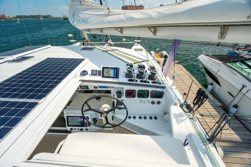 Slide: The Image of Modern Balance 526 yacht cockpit with solar panels and navigation equipment, docked at a marina. - 17
