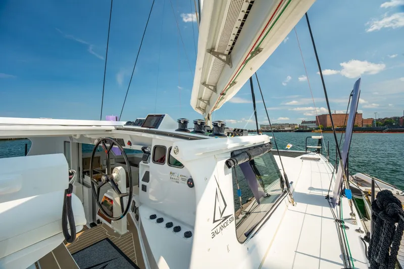 Slide: The Image of Modern Balance 526 sailboat cockpit with steering wheel, ocean view, and clear blue sky. - 18