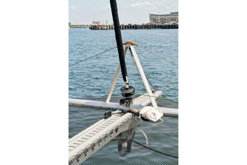 Slide: The Image of Sailing catamaran Balance 526, 2025 model, on calm water near a harbor. - 126