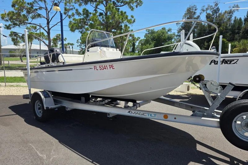 The Image of 2011 Boston Whaler 170 Montauk boat on trailer, parked outdoors under clear sky. - 1