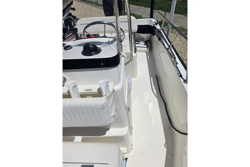 Slide: The Image of 2011 Boston Whaler 170 Montauk boat interior with steering console and seating. - 15