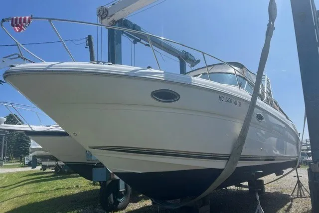 The Image of 2002 Sea Ray 290 Amberjack boat on a lift, sunny day. - 0