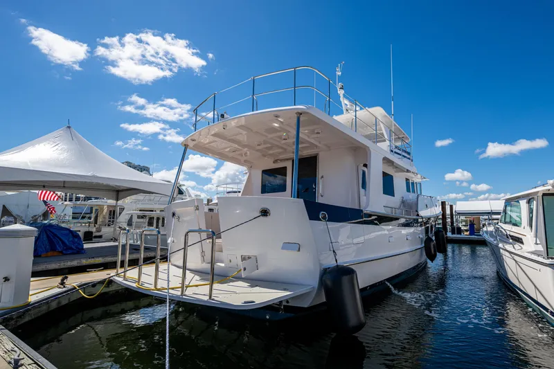 Slide: The Image of 2026 Kadey-Krogen 60 Open yacht docked under clear blue sky. - 102